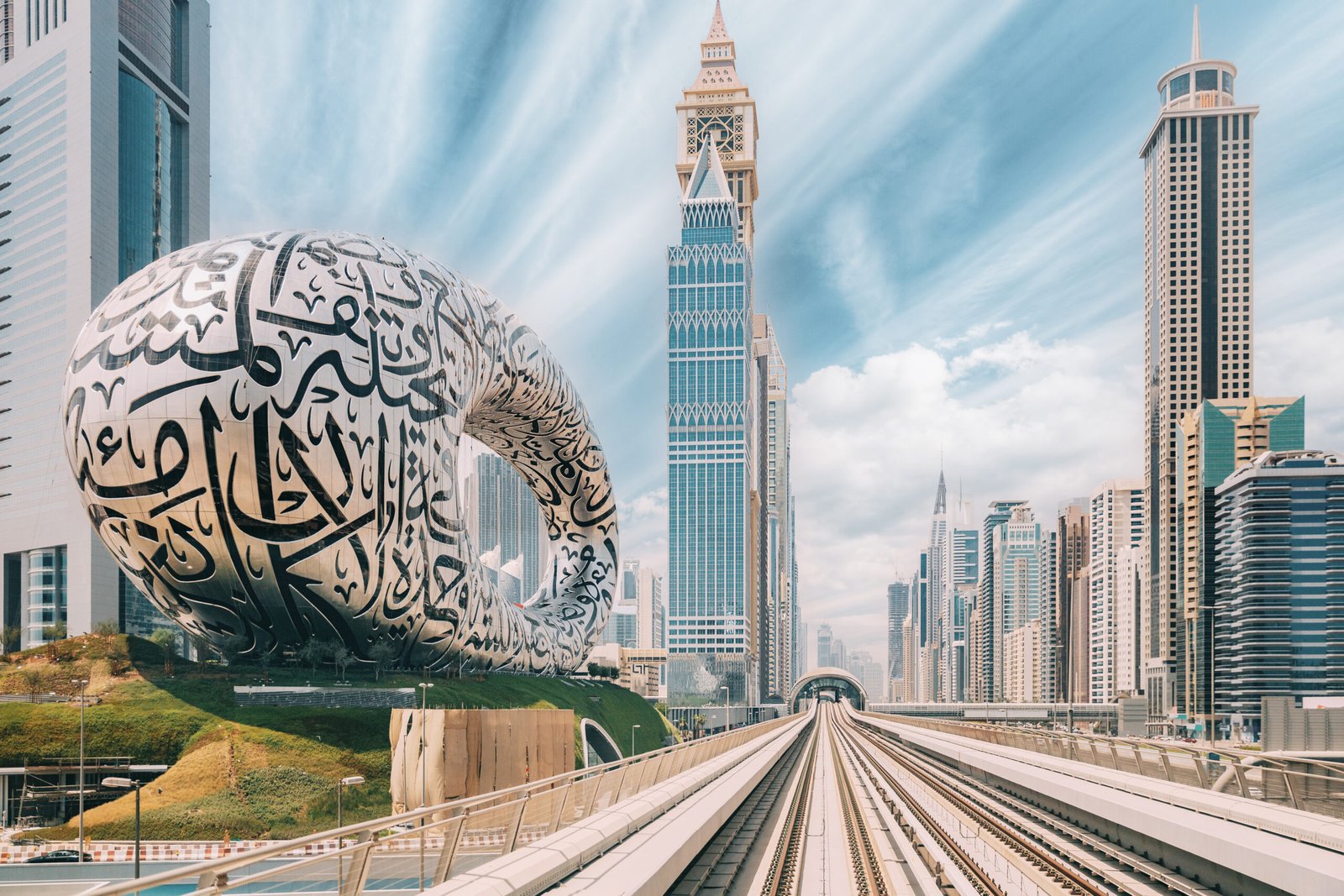 Metro railway among among glass skyscrapers in Dubai. Traffic on street in Dubai. Museum of the Future in Dubai. Cityscape skyline. Urban background.